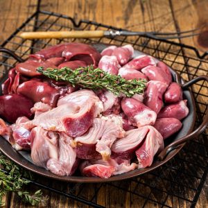 raw-bird-giblets-meat-set-chicken-offals-liver-hearts-gizzards-stomach-wooden-background-top-view_89816-37494